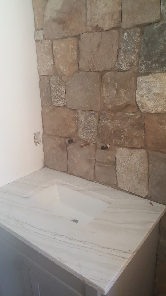1-stone wall behind sink